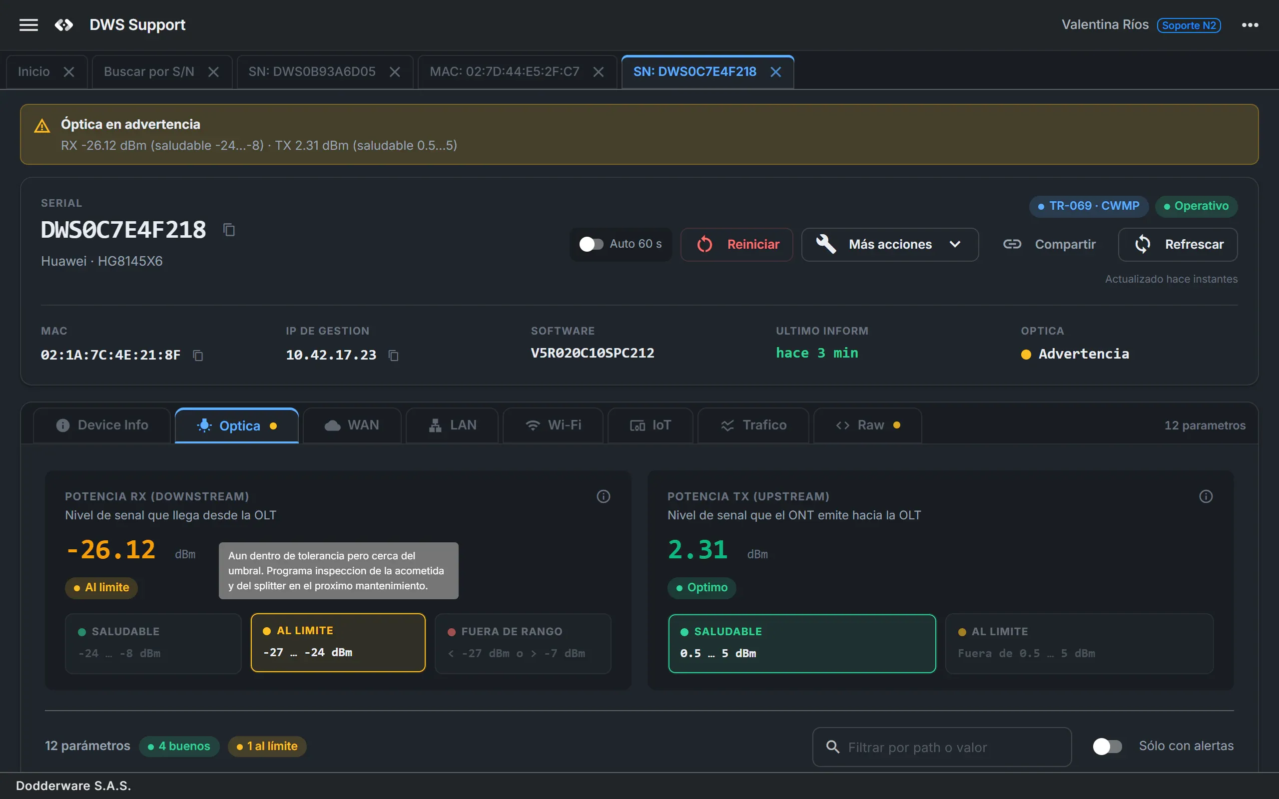 DWS Support device detail on the Optics tab for an operational TR-069 ONT, showing a borderline -26.12 dBm RX reading with its field hint, the status and protocol chips, the remote actions and several device tabs open.